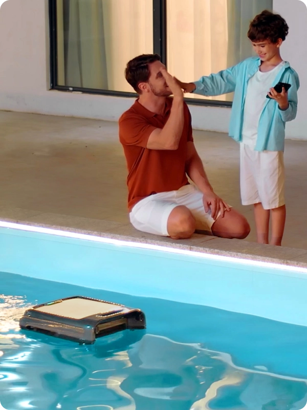 Father and son using Aiper Surfer S2 skimmer together by the pool.