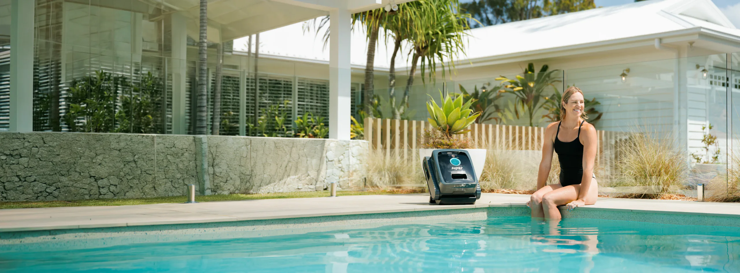 Emily Seebohm beside an Aiper pool cleaner